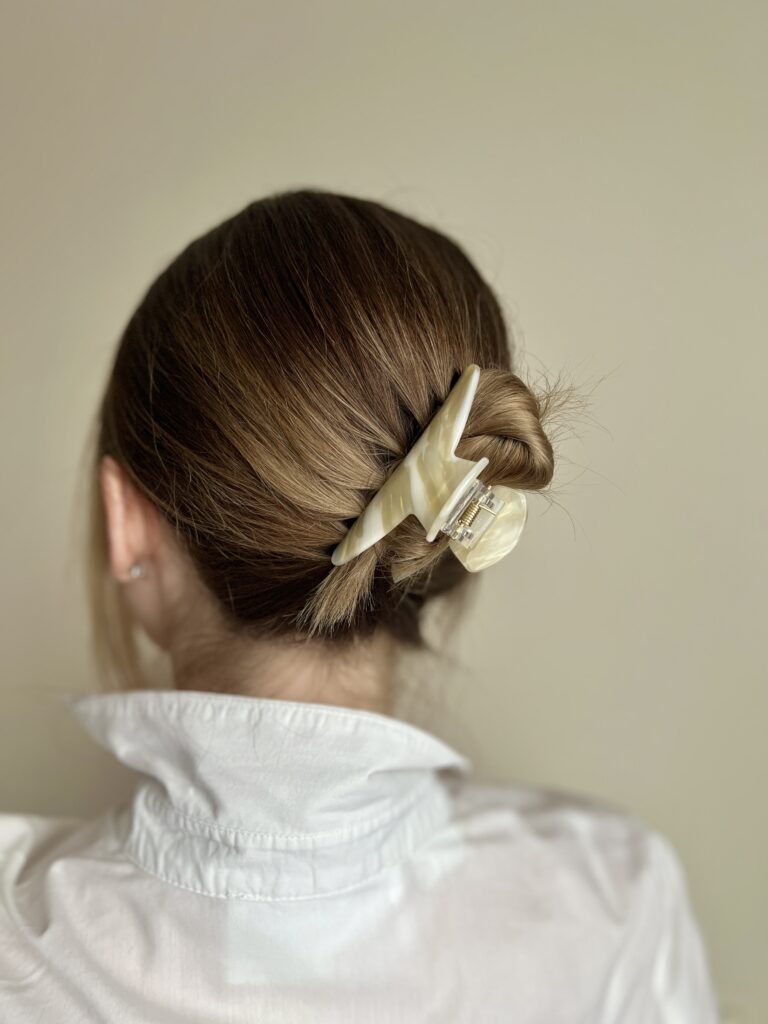 Susegti visi plaukai su šviesios spalvos plaukų segtuku žnyplėmis