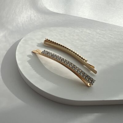 Metaliniai aukso spalvos segtukai dekoruoti skaidriais blizgančiais akmenukais