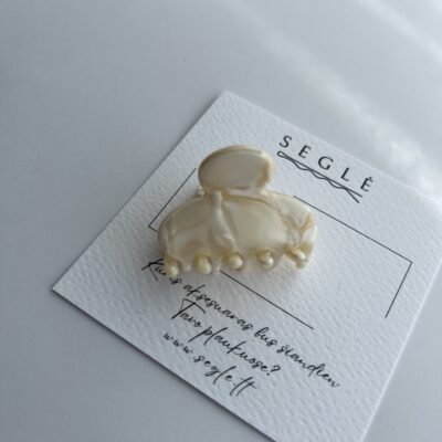 Nedidelis plaukų segtukas žnyplės. Segtukas šviesios gelsvos ir baltos spalvos