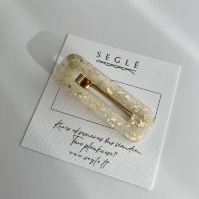 Metalinis aukso spalvos plaukų segtukas su plastikiniu paviršiumi.