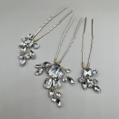 Metaliniai šviesios aukso spalvos plaukų smeigtukai dekoruoti skaidriais kristaliukais, kurie išdėstyti šakelių forma